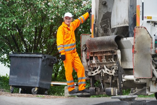 Mini skip being loaded with waste